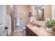 Stylish bathroom featuring a granite countertop and decorative mirror at 2224 N 83Rd Cir, Mesa, AZ 85207