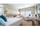 Spacious bedroom featuring two beds, built-in cabinets, and plantation shutters for ample natural light at 2224 N 83Rd Cir, Mesa, AZ 85207