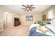 Bright bedroom features a ceiling fan, carpet and a serene color palette at 2224 N 83Rd Cir, Mesa, AZ 85207