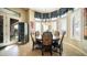 Elegant dining room with a round table set, large windows, and a wine cooler, perfect for entertaining guests at 2224 N 83Rd Cir, Mesa, AZ 85207