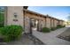 A gated courtyard leading to the front entrance with desert landscaping and stone accents, showcasing the home's curb appeal at 2224 N 83Rd Cir, Mesa, AZ 85207