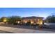 Beautiful exterior of a stone-clad home with desert landscaping, enhanced by charming outdoor lighting for evening appeal at 2224 N 83Rd Cir, Mesa, AZ 85207
