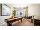 Entertaining game room featuring a shuffleboard table, natural lighting, and comfortable seating at 2224 N 83Rd Cir, Mesa, AZ 85207