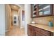 Hallway featuring tile floors, recessed lighting, and granite countertop with wooden cabinets in a neutral color scheme at 2224 N 83Rd Cir, Mesa, AZ 85207