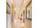 Inviting hallway with tile flooring, arched doorways, and elegant decor at 2224 N 83Rd Cir, Mesa, AZ 85207