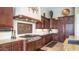 Gourmet kitchen showcasing custom cabinets, stainless steel range, and elegant tile backsplash at 2224 N 83Rd Cir, Mesa, AZ 85207