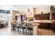 Spacious gourmet kitchen with dark wood cabinets, granite countertops, and stainless steel appliances at 2224 N 83Rd Cir, Mesa, AZ 85207