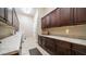 A bright laundry room with dark cabinets and tiled floor at 2224 N 83Rd Cir, Mesa, AZ 85207