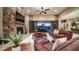 Spacious living room with a stone fireplace and sliding glass doors that offer a view of the backyard at 2224 N 83Rd Cir, Mesa, AZ 85207