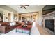 Open-concept living room with a stone fireplace and views into the kitchen and dining areas, perfect for gatherings at 2224 N 83Rd Cir, Mesa, AZ 85207