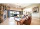 Bright living room with a stone fireplace and sliding glass doors leading to the outdoor living space and pool at 2224 N 83Rd Cir, Mesa, AZ 85207