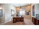 Well-lit office space featuring a large executive desk, ample storage, and decorative touches at 2224 N 83Rd Cir, Mesa, AZ 85207