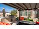Covered outdoor kitchen with a built-in grill and bar, perfect for entertaining guests at 2224 N 83Rd Cir, Mesa, AZ 85207