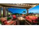 Cozy covered patio with a fire pit, cushioned seating, and string lights, perfect for evening relaxation and entertaining at 2224 N 83Rd Cir, Mesa, AZ 85207