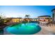 Gorgeous backyard pool with lush landscaping, a built-in spa, and an outdoor kitchen at 2224 N 83Rd Cir, Mesa, AZ 85207