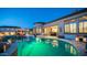 Stunning backyard pool at dusk with beautiful landscaping and a covered patio at 2224 N 83Rd Cir, Mesa, AZ 85207