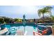 Beautiful backyard pool with mature landscaping, rock accents, and comfortable seating at 2224 N 83Rd Cir, Mesa, AZ 85207