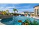 Resort style pool with rock waterfall feature, lush landscaping and lounge seating at 2224 N 83Rd Cir, Mesa, AZ 85207