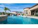 Resort style pool with rock waterfall feature, lush landscaping and lounge seating at 2224 N 83Rd Cir, Mesa, AZ 85207