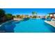 Sparkling blue pool surrounded by lush landscaping and stone accents, creating a luxurious outdoor oasis at 2224 N 83Rd Cir, Mesa, AZ 85207