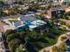 Aerial view of the home, grass, tall trees, pool, landscaping, and beautiful surroundings at 2251 N 32Nd St # 10, Mesa, AZ 85213