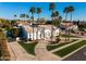 Aerial view of a white stucco home with palm trees, desert landscaping, and tile roof at 2251 N 32Nd St # 10, Mesa, AZ 85213