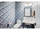Chic powder room with a geometric wallpaper, stylish mirror and brass hardware at 2251 N 32Nd St # 10, Mesa, AZ 85213