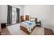 Inviting bedroom featuring a window with shutter, and a charming wooden bed frame at 2251 N 32Nd St # 10, Mesa, AZ 85213