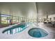 Gorgeous indoor pool and spa with a tile surround, lounge chairs, and exterior views at 2251 N 32Nd St # 10, Mesa, AZ 85213