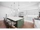 Modern kitchen with white cabinets, a large island, and pendant lighting at 2251 N 32Nd St # 10, Mesa, AZ 85213