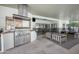 Outdoor kitchen with a stainless steel BBQ, tile flooring, and comfortable lounge chairs at 2251 N 32Nd St # 10, Mesa, AZ 85213