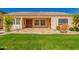 Charming covered back patio with a colorful patterned concrete, lush green grass and tidy landscaping at 2263 E Jade Ct, Chandler, AZ 85286