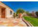 Side view of the backyard, with stone-lined garden, manicured lawn, and appealing patio at 2263 E Jade Ct, Chandler, AZ 85286