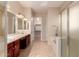 Spacious bathroom featuring dual sinks, a soaking tub, and a glass-enclosed shower at 2263 E Jade Ct, Chandler, AZ 85286