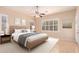 Comfortable bedroom with neutral colors, large windows, ceiling fan and tiled floor at 2263 E Jade Ct, Chandler, AZ 85286