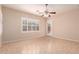 This bedroom features a ceiling fan, tiled floor, and a large window with shutters at 2263 E Jade Ct, Chandler, AZ 85286