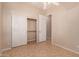 Bedroom featuring a ceiling fan, tiled floor, closet, and multiple windows at 2263 E Jade Ct, Chandler, AZ 85286