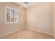 Cozy bedroom with a tile floor, white shuttered window, and a ceiling fan at 2263 E Jade Ct, Chandler, AZ 85286