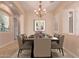 Elegant dining area with a chandelier, shutters, and formal dining table at 2263 E Jade Ct, Chandler, AZ 85286