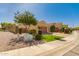 Tan single story home with desert landscaping, shade tree and a 2 car garage at 2263 E Jade Ct, Chandler, AZ 85286
