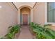 Covered front entry with a paneled front door and desert landscaping at 2263 E Jade Ct, Chandler, AZ 85286
