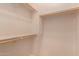 Bright walk-in closet featuring built-in shelving and wooden racks for optimal storage at 2263 E Jade Ct, Chandler, AZ 85286