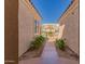 A walkway between 2 buildings with a gate leading to the backyard at 2263 E Jade Ct, Chandler, AZ 85286