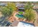 Aesthetic aerial view of the landscaped backyard, showcasing a sparkling swimming pool and patio area at 24522 W Mark Ln, Wittmann, AZ 85361