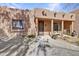 Charming front exterior highlighting the inviting entrance with a seating area and desert landscaping at 24522 W Mark Ln, Wittmann, AZ 85361