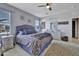 Bright main bedroom featuring a ceiling fan, carpet, a chandelier, and ensuite bathroom at 24522 W Mark Ln, Wittmann, AZ 85361