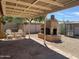 Enjoyable backyard with a built-in fireplace, a pergola, and space for outdoor seating at 24638 N 65Th Ave, Glendale, AZ 85310
