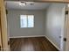 Bedroom featuring wood-look floors, neutral walls, and a window with blinds at 24638 N 65Th Ave, Glendale, AZ 85310