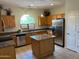 Eat-in kitchen featuring wooden cabinets, stainless steel appliances, and granite countertops at 24638 N 65Th Ave, Glendale, AZ 85310