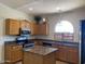 Well-lit eat-in kitchen featuring a center island and stainless steel appliances at 24638 N 65Th Ave, Glendale, AZ 85310